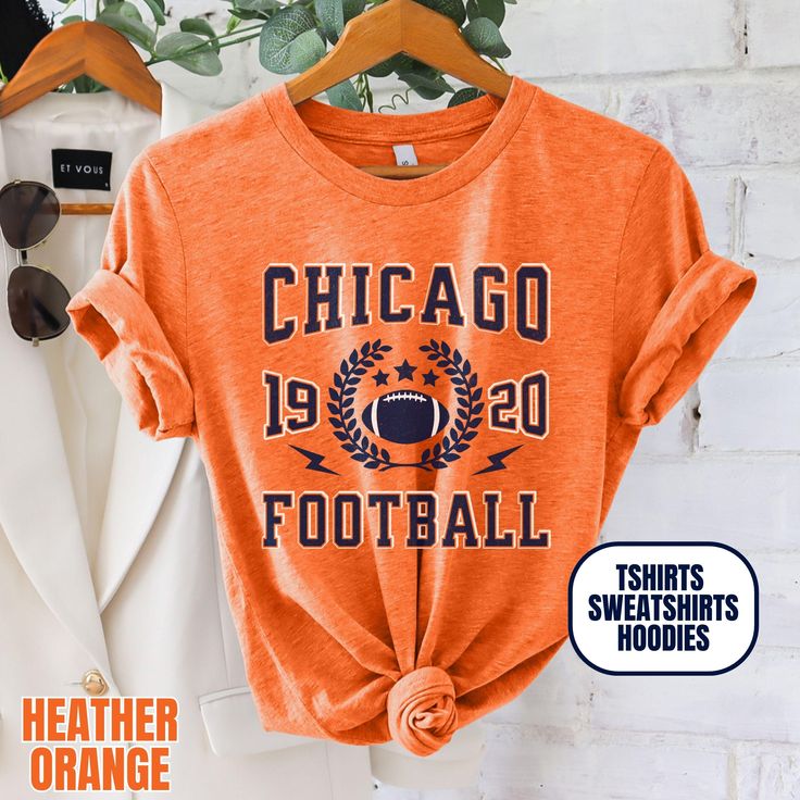 Please Note: This listing contains multiple shirt types. To insure you are getting the item you expect, please review all options and photos carefully before ordering. Our Chicago Football Apparel is the perfect way to cheer on your team this season. Choose from short sleeve tees, sweatshirts or hoodies. Makes a great gift for any fan. Perfect for game day, tailgates or everyday wear.  SHIRT DETAILS Bella Canvas Unisex - Solid colors: 100% Cotton. - Heather colors: 52% Cotton + 48% Polyester - Runs true to size. (For looser or oversized fit consider going up a size or 2. See photos for size chart.) SWEATSHIRT & HOODIE DETAILS Gildan Heavy Blend Unisex - 50% Cotton + 50 Polyester - Runs true to size. (For looser or oversized fit consider going up a size or 2. See photos for size chart.) CAR Orange Crew Neck Top For Sports Season, Orange Letter Print Crew Neck Hoodie, Fall Team Spirit T-shirt For Streetwear, Sporty Orange Sweatshirt With Letter Print, Orange Sporty Crew Neck Hoodie, Orange Crew Neck Top For Sports Events, Orange Crew Neck Sporty Hoodie, Team Spirit Sports T-shirt For Fall, Fall Varsity Sports T-shirt