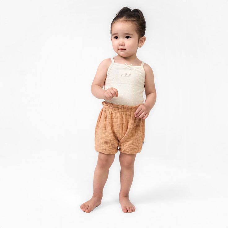 Elevate your child's summer wardrobe with this three pack of baby girl shorts. Made from a lightweight cotton gauze that’s gentle on sensitive skin, these shorts feature a comfort-stretch waistband for an easy fit. These shorts are perfect for those sunny days, ensuring your little one stays cool during outdoor activities and adventures. With a range of colors in this collection, you can effortlessly mix and match various outfits, making them a versatile addition to your child's clothing assortment. And for convenient care throughout the season, just pop them in the washing machine or dryer as needed. Our essentials have been independently certified with STANDARD 100 by OEKO-TEX® so that you don’t have to worry about harmful substances in your baby’s wardrobe. Pack includes three shorts. | Playful Short Bloomers For Summer, Playful Summer Short Bloomers, Summer Bottoms With Elastic Waistband For Playtime, Summer Diaper Cover With Elastic Waistband, Playful Summer Bloomers With Elastic Waistband, Summer Playtime Diaper Cover With Elastic Waistband, Playful Beach Bloomers, Short Bloomers For Spring Playwear, Spring Short Bloomers For Playwear