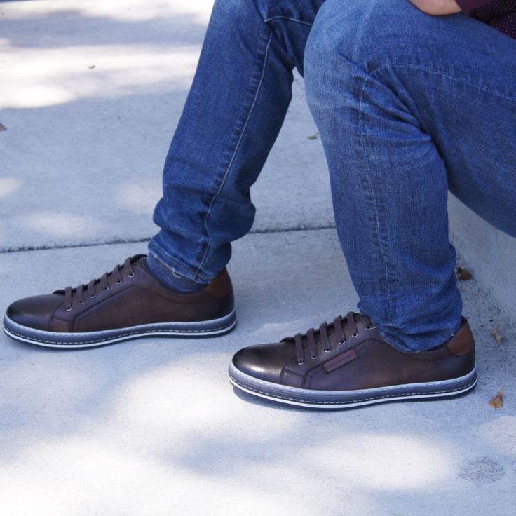 Men's long facing six (6) eyelet derby shoe in full grain soft burnished and polished leather featuring a comfortable padded sports style top-line with contrast leather logo and heel trim, all on a three-color side wall stitched rubber out-sole. Brown Low-top Lace-up Shoes For Business Casual, Brown Casual Cap Toe Leather Shoes, Casual Brown Cap Toe Leather Shoes, Casual Brown Cap Toe Lace-up Shoes, Masculine Brown Lace-up Oxfords, Brown Low-top Shoes For Business Casual, Casual Low-top Goodyear Welted Leather Shoes, Casual Low-top Leather Shoes With Goodyear Welt, Brown Low-top Leather Derby Shoes