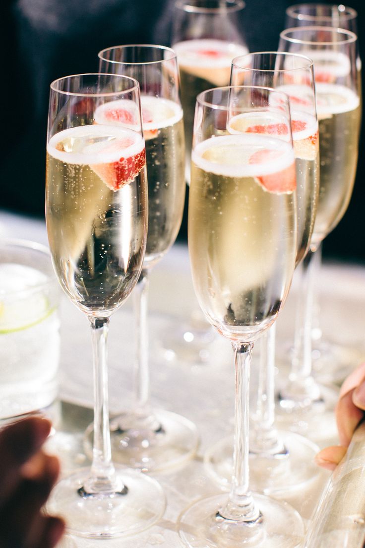 several glasses of champagne are lined up on a tray