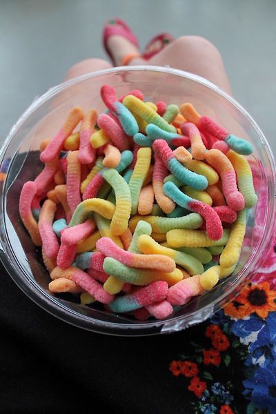 a bowl filled with lots of colorful candy worms