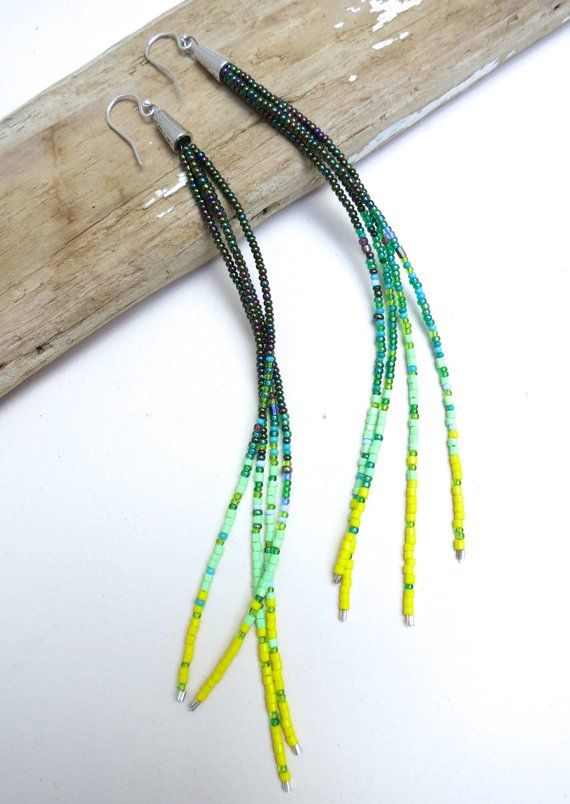 "Spring Chain" A playful harmony of cool dark green seed beads rest against threads of soft grass green and a pop of yellow. These long earrings feature a splash of mint and creamy blue accents. A pop of subtle spring colors make these earrings easy to wear as a daily favorite. 925 silver earwires finish the look.Please choose your length at check out:4 inches6 inches9 inchesPhotos show our extra long pair of earrings measuring 9 inches from top of earwire to bottom.Your jewelry will come beauti Cheap Green Beaded Earrings For Summer, Green Dangling Beads For Festival, Green Multi-strand Jewelry With Dangling Beads, Handmade Green Beaded Earrings For Festivals, Green Beaded Chain Earrings With Round Beads, Adjustable Green Earrings With Tiny Beads, Green Earrings With Beaded Chain And Round Beads, Green Tiny Multi-strand Beads, Green Tiny Beads Jewelry For Crafting