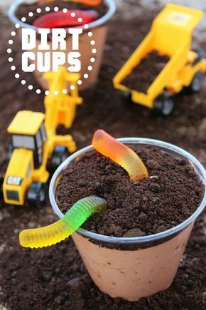 dirt cups filled with dirt and toys on top of a table next to each other