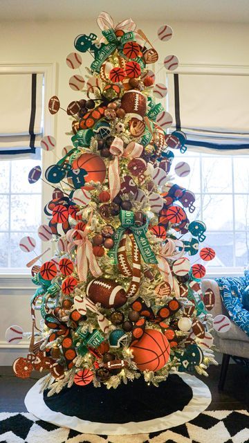 a christmas tree decorated with basketballs, bows and other holiday decorations in a living room