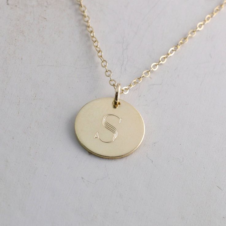 "Solid gold engraved initial necklace is a family heirloom that will be cherished and treasured for many years... it is the PERFECT gift! PICTURE IS ENLARGED TO SHOW DETAIL! SEE SECOND PICTURE FOR SIZE COMPARISON. PLEASE READ BELOW FOR ACTUAL MEASUREMENTS!! Your choice of one, two, or three solid gold 1/2\" (13mm) discs have been personalized just for you with a classy block font in a large 7mm size and it is GORGEOUS! (Font is shown in picture #6 above) The pendants hang from a solid 14k gold 1 Classic Necklaces With Initial Pendant For Anniversary, Classic Necklaces For Anniversary With Initial Pendant, Classic Engraved Initial Necklace As Gift, Classic Pendant Initial Necklace As A Gift, Classic Engraved Initial Necklace For Gift, Classic Charm Necklace For Anniversary, Classic Nameplate Initial Necklace As Gift, Classic Initial Pendant Charm Necklace For Wedding, Anniversary Jewelry With Initial Pendant