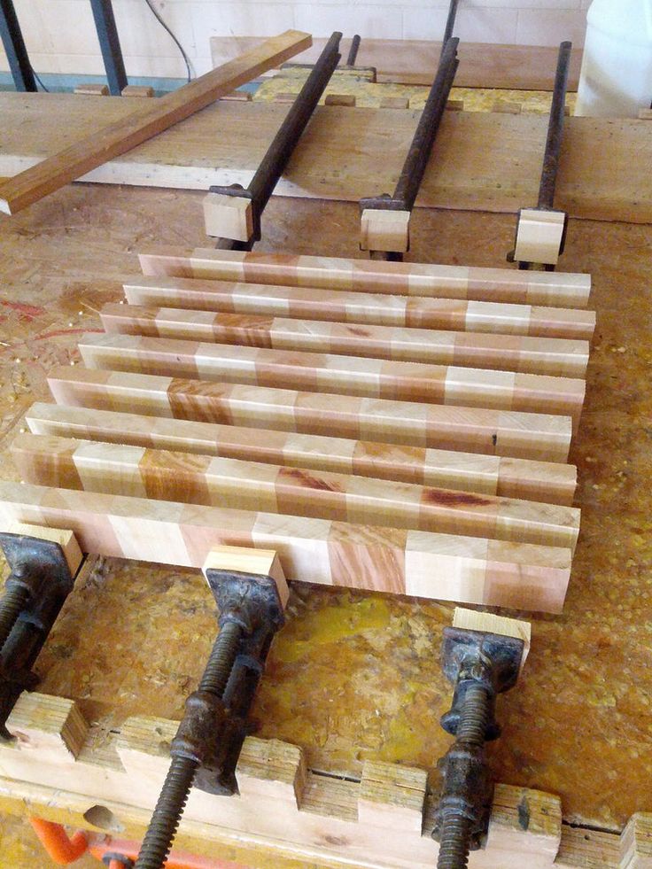 several pieces of wood sitting on top of a wooden table next to some screws