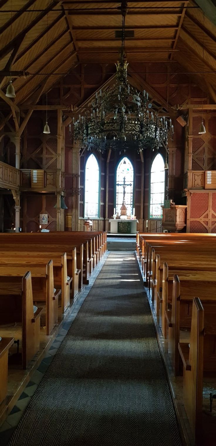 an empty church with pews and chandelier