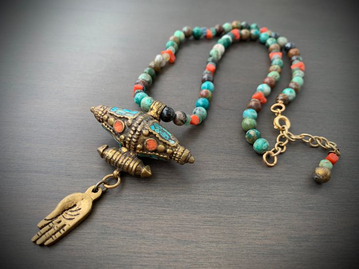 This layer necklace looks great alone or paired with many of my other designs. The little hand and large focal bead is beautifully handcrafted in Nepal from brass with salmon and aqua inlay. This hangs from a strand made with chrysocolla, vintage coral and ancient Roman glass heishi beads. Closes with c clasp and measures 16" with a 2 1/2" chain extension that is finished off with complimentary beads on the end. Rome Antique, Ancient Roman Glass, Roman Glass, Layer Necklace, Heishi Beads, Focal Bead, Bead Necklace, Layered Necklaces, Nepal