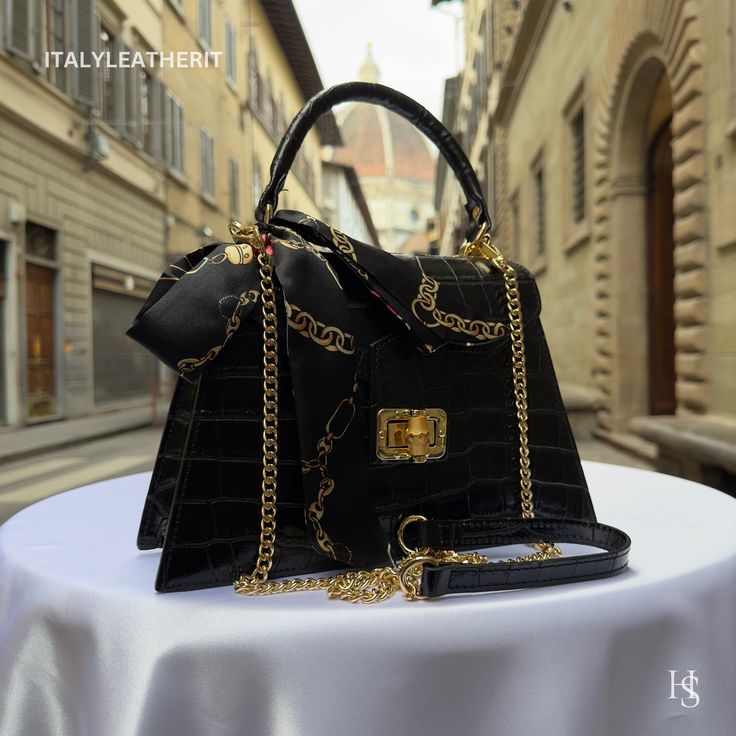 This bag has been made of the best genuine leather by local master crafters of Florence in Italy, designed for women who only accept premium Italian quality and luxury leather bags and modern Italian fashion. . Sizes: Width:   27 cm/10.75 inch Height:  19 cm/7.50 inch Depth:    9 cm/3.50 inch Color: Black . The story behind this bag: It was the day of her mother's birthday, and Giulia wanted to give her something special. Her mother had always been an inspiration to her, and she wanted to express her love and gratitude through a meaningful gift. After some research, she found the perfect gift - an elegant leather bag handmade in Florence, Italy. The bag was crafted with care and precision, using only the finest Italian leather. It was a luxurious tote bag that exuded elegance and sophistic High-end Black Shoulder Bag For Gift, Luxury Faux Leather Bag For Daily Use, Luxury Faux Leather Satchel For Daily Use, Luxury Faux Leather Handheld Satchel, Luxury Handheld Faux Leather Satchel, High-end Leather Crossbody Evening Bag, Luxury Satchel With Removable Pouch As Gift, Designer Leather Bags As Gifts, Designer Leather Bags For Gifts