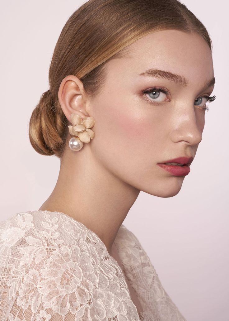 Petals and pearls! Our 'Organna' stud is made from hand sew silk flowers accented with an oversized pearl. A modern take on a classic pearl stud, in keeping with our love for dimension and femininity. Big on impact and lightweight - get ready to turn heads this Saturday night! Available in either Rhodium/Ivory or Gold/Ivory or Gold/Blush colorway. Available in either a Post back or Clip backing Elizabeth Bower logo plate 1.18"/30mm wide x 1.77"/45mm wide Shipped in gift packaging with care instructions. White Feminine Pearl Earrings, Feminine Pearl Earrings For Evening, Feminine Evening Pearl Earrings, Elegant Summer Wedding Pearl Earrings, Elegant Pearl Earrings With Pearl Charm For Summer, Chic Pearl Earrings For Wedding, Feminine White Pearl Earrings For Evening, Elegant White Pearl Earrings For Summer, Elegant Pearl Charm Earrings For Summer