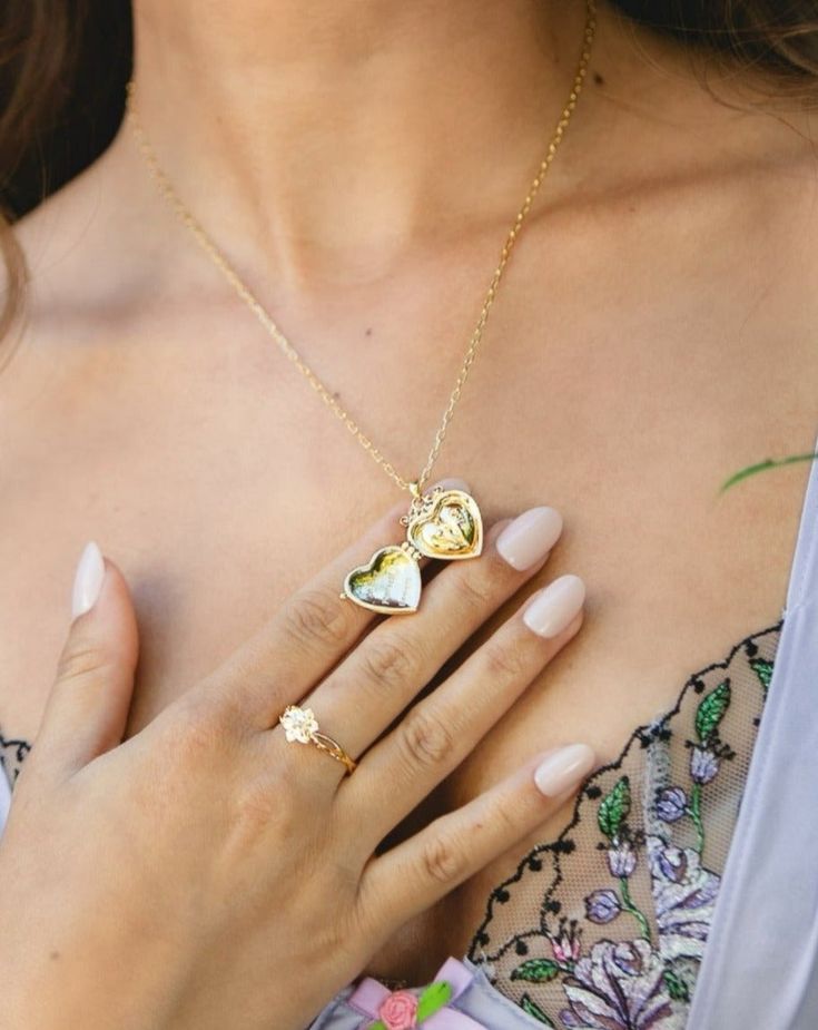 Discover the charm of Isabela Locket, a heart-shaped necklace that whispers stories of romance. On its exterior, a rose design symbolizes enduring love, while inside, a tulip pattern celebrates hidden depths of affection. This elegant locket is a perfect symbol of love's intricate beauty, ideal for gifting or as a personal keepsake. Materials: 18K gold plated brass Measurements: 410mm/16.14" in length, 70mm/2.76" in extension length En Route Jewelry, Tulip Pattern, Heart Shaped Necklace, Liberia, Zimbabwe, Gift List, Zambia, Sierra Leone, Love Symbols