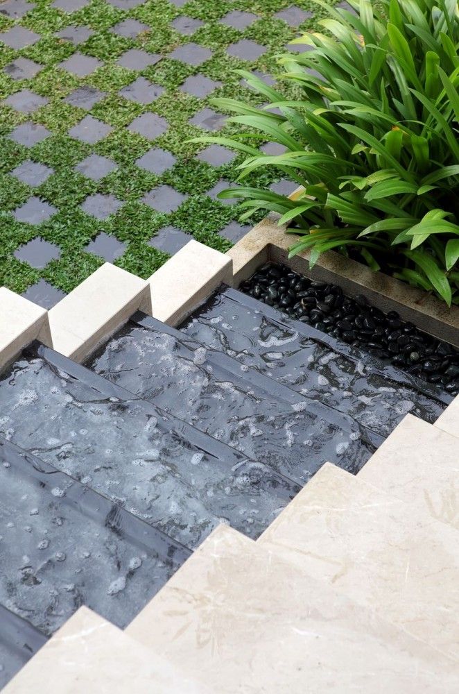 a water feature in the middle of a garden