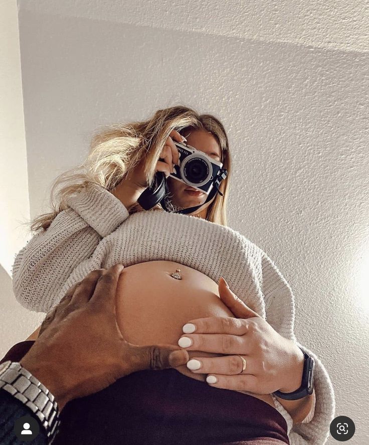 a woman is taking a selfie with her baby bump in the middle of her stomach