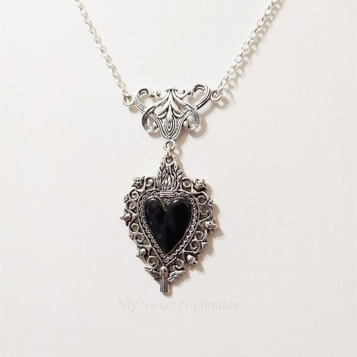 This pendant necklace is made of a zinc alloy and features a burning heart design, making it perfect for any occasion. Its chain can be adjusted to fit your look, or removed completely. It also comes with a gift box for easy storage. Product Specification: Style: Neo-Gothic Shape\pattern: Heart Occasion: Party Necklace Type: Pendant Necklaces Metals Type: Zinc alloy Material: Metal Item Type: Necklaces Function: Message Reminder Compatibility: All Compatible Chain Type: Link Chain Sacred Heart Necklace, Burning Heart, Witch Jewelry, Heart Choker, Silver Lace, Party Necklace, Jewelry Black, Vintage Gothic, Memento Mori