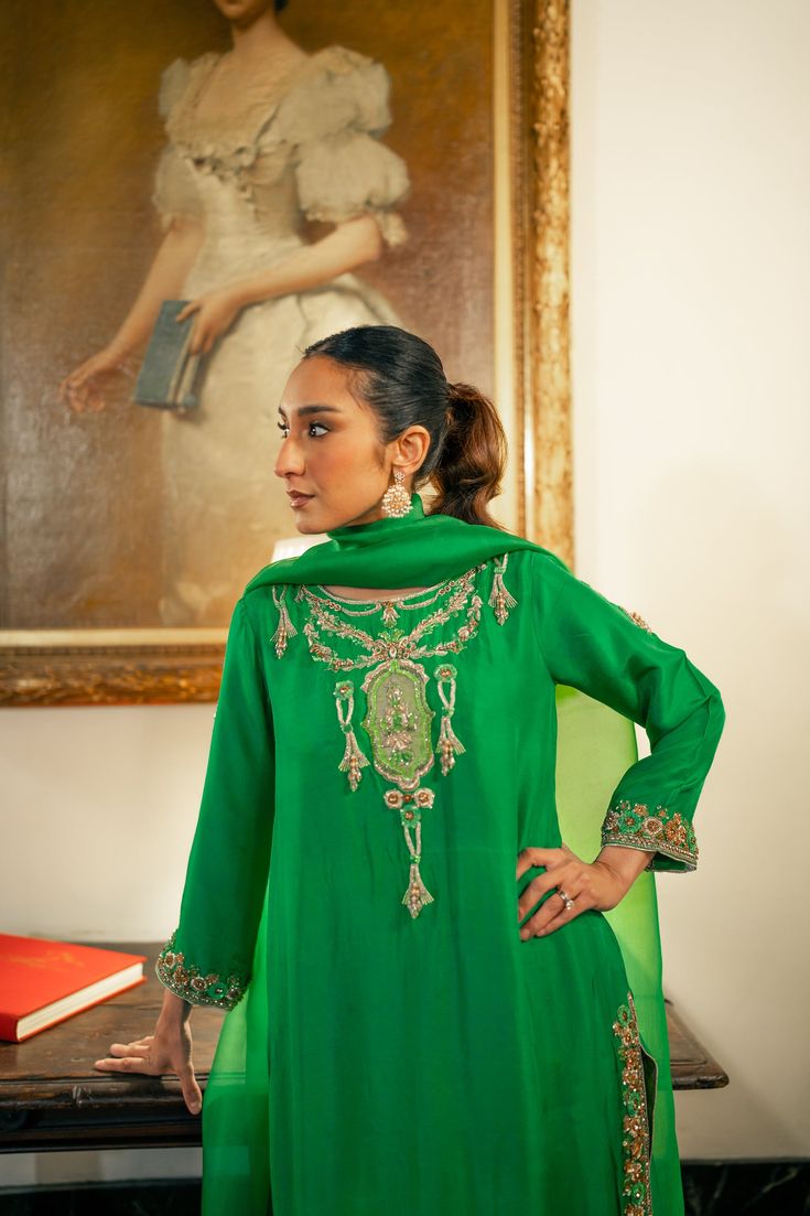 3 piece suit comes with matching pants, and dupatta. Shirt length: 45 inches The shirt and pants are made of pure raw silk and the dupatta is organza. This item includes the following handwork: aari, kora, and zardozi with pearls, sequins, and resham thread. This outfit including the sleeves is not see through. Orders cannot be changed or cancelled after 30 minutes of completion of the order. We do not offer returns or exchanges on this item. We cannot make any exceptions to this policy since th Designer Raw Silk Sets With Dabka Work, Elegant Semi-stitched Tissue Silk Set, Designer Chinon Palazzo Set With Dabka, Silk Lawn Suit With Traditional Drape For Festive Occasions, Traditional Drape Silk Lawn Suit For Festive Occasions, Elegant Tissue Silk Palazzo Set With Dabka Work, Elegant Green Palazzo Set For Festive Occasions, Elegant Green Festive Palazzo Set, Raw Silk Salwar Kameez With Dabka Work, Straight Kurta