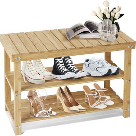 a wooden shoe rack with two pairs of shoes on it