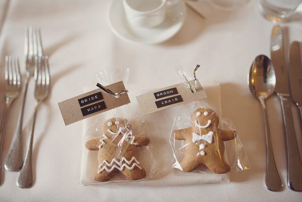 two small gingerbreads in plastic bags on a table with forks and silverware