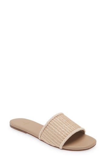 A woven raffia vamp enhances the sunny-day appeal of a minimalist slide sandal lined in soft leather and grounded by a slim rubber sole. Synthetic and textile upper/leather lining/rubber sole Imported Hispanic & Latinx Owned/Founded Woven Leather Sandals For Summer, Neutral Straw Sandals With Cushioned Footbed, Summer Sandals With Textured Footbed In Natural Color, Natural Straw Sandals With Cushioned Footbed, Natural Straw Sandals With Textured Footbed, Summer Sandals With Woven Leather For Spring, Spring Summer Sandals With Woven Leather, Chic Woven Sandals For Summer Outings, Beach Woven Natural Slides