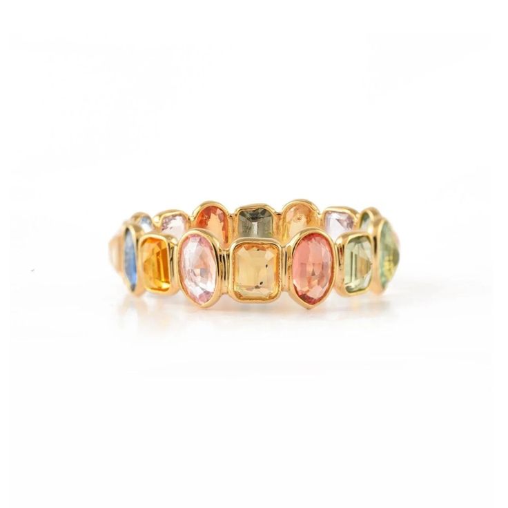 an 18k yellow gold ring with multicolored stones on the sides and two rows of different sizes