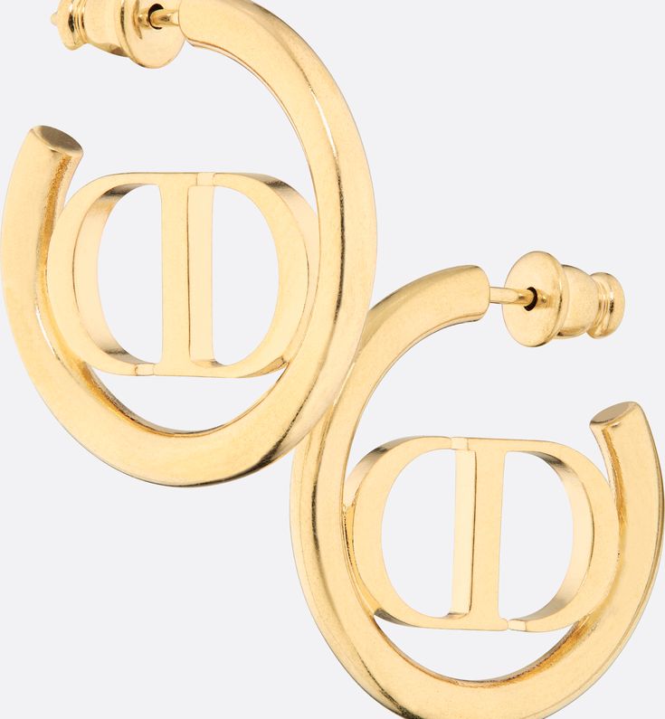 The 30 Montaigne earrings have a modern and elegant aesthetic. The finely crafted gold-finish metal ring encircles the 'CD' signature placed at the center. The earrings can be styled with other creations from the 30 Montaigne line.. Designer Gold-tone Logo Plaque Earrings For Formal Occasions, Luxury Gold-tone Tarnish-resistant Earrings, Designer Yellow Gold Jewelry With Gold-tone Hardware, Luxury Gold-tone Earrings With Logo Plaque, Classic Yellow Gold Earrings With Logo Plaque, Elegant Gold-tone Earrings As Gift, Elegant Gold-tone Earrings For Gift, Luxury Pierced Yellow Gold Hoop Earrings, Luxury Yellow Gold Pierced Hoop Earrings