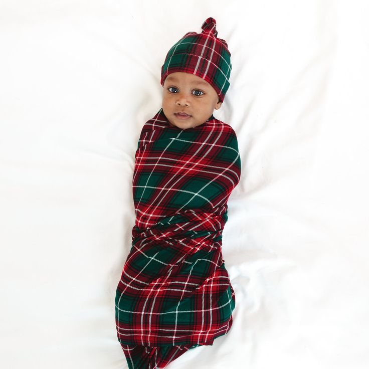 Infant laying on a blanket swaddled in a Fireside Plaid Swaddle & Hat Set Family Holiday Cards, Holiday Baby, Box Making, Baby Gown, Hat Set, Holiday Style, Fall Favorites, Family Holiday, Burp Cloths