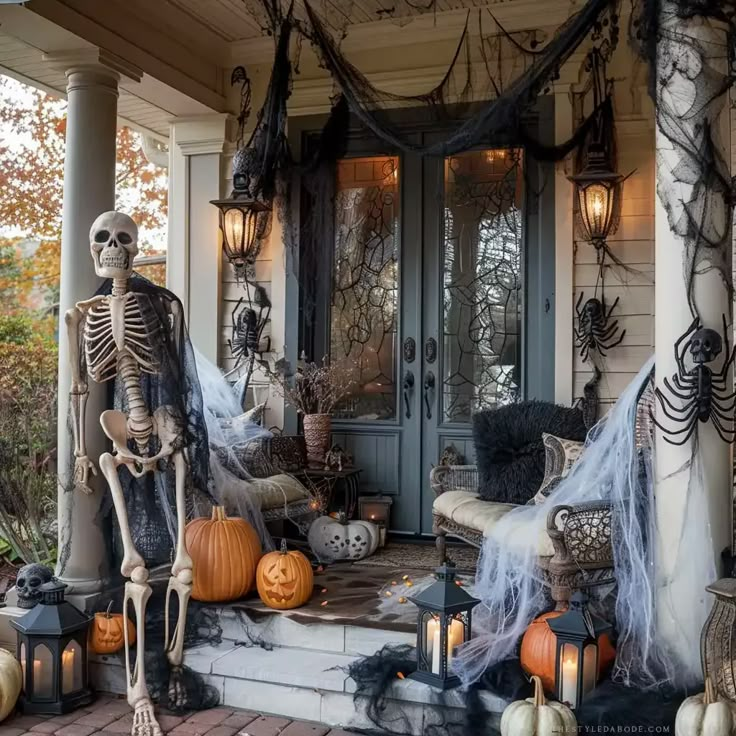 a porch decorated for halloween with skeletons and pumpkins