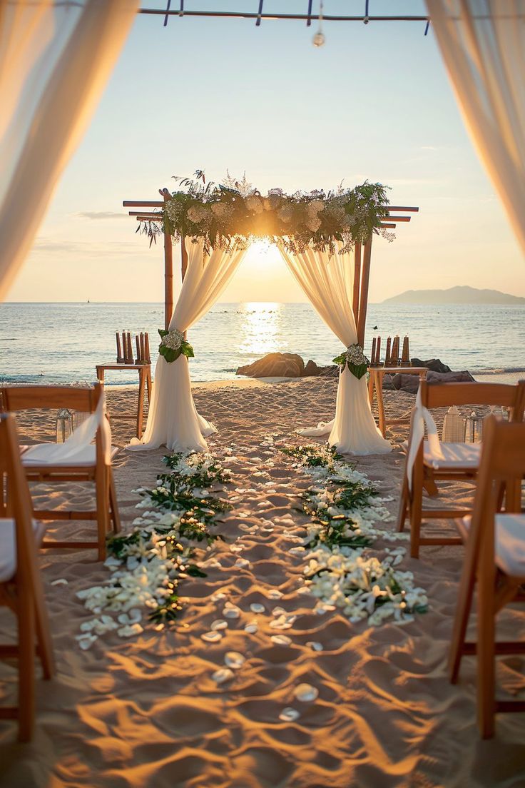 an outdoor wedding setup on the beach at sunset