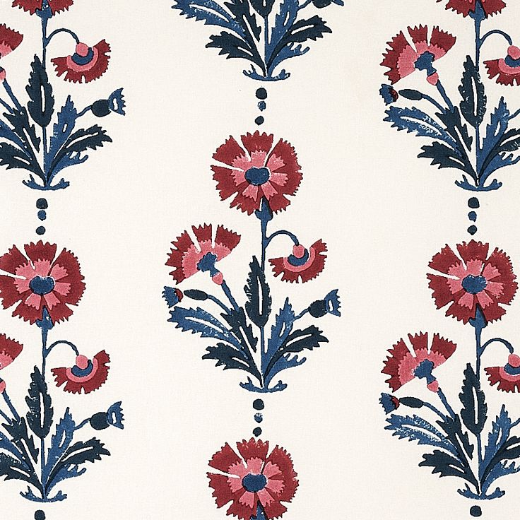 a red and blue floral design on white fabric