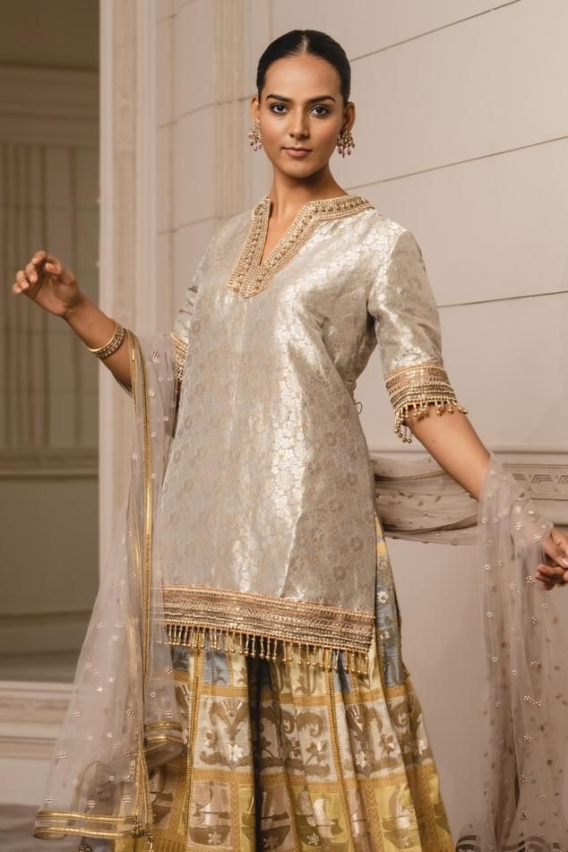 Yellow sharara in jacquard base. Paired with a matching embroidered kurta having gold crystal fringes and a chanderi dupatta having brocade borders
Component: 3
Pattern: Embroidered, Woven
Type Of Work: Floral, Animal and Boat Pattern
Neckline: Notched
Sleeve Type: Elbow
Fabric: Sharara: Jacquard, Dupatta: Chanderi, Kurta: Brocade
Color: Yellow
Other Details: 
Sheer dupatta with buttis
Tassel fringed hem
Occasion: Sangeet - Aza Fashions Elegant Jamawar Sharara With Traditional Drape, Bollywood Style Jamawar Sharara For Reception, Elegant Jamawar Sharara For Reception, Elegant Fitted Sharara In Jamawar, Elegant Jamawar Sharara For Diwali, Elegant Fitted Jamawar Sharara, Eid Reception Jamawar Sharara, Unstitched Jamawar Sharara For Reception, Jamawar Sharara For Reception With Traditional Drape