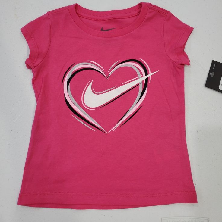 Nwt Bin K.L S Nike Sporty Shirt For Spring, Nike Sporty Spring Shirt, Cute Logo Print Tops For Spring, Cute Spring Tops With Logo Print, Playful Heart Graphic Tops For Spring, Sporty Logo Print Shirt For Spring, Playful White Nike Tops, Pink Logo Print Shirt For Spring, Spring Pink Shirt With Logo Print