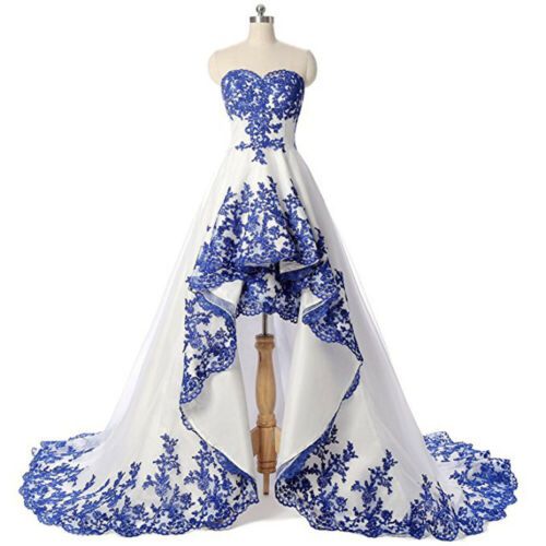 a blue and white wedding dress on display in front of a white backdrop with flowers