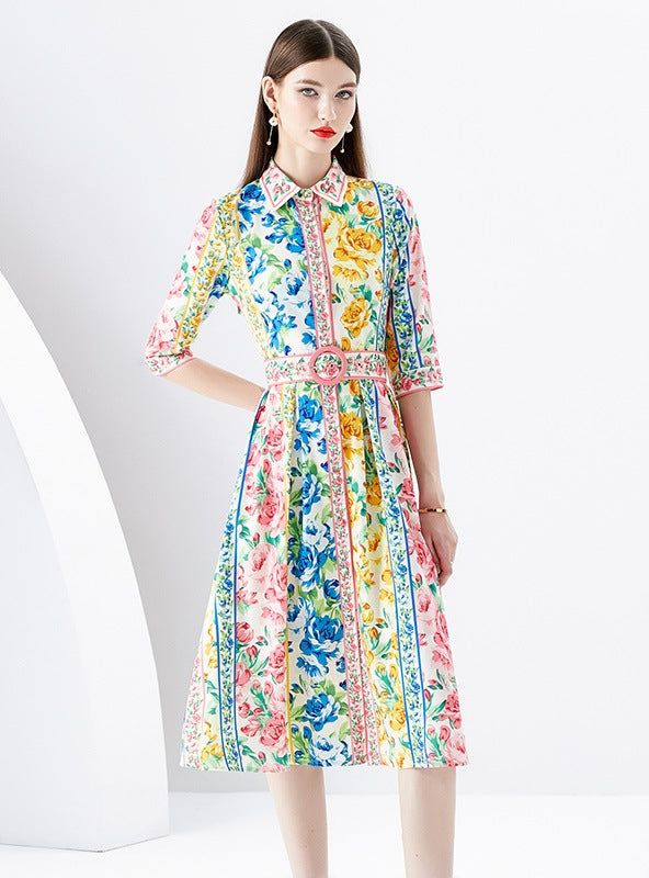 "Brilliantly blossoming with an exuberant array of flowers, this midi dress is an ode to the vibrant palette of a lush, sun-drenched garden. The artful symphony of roses, daisies, and wildflowers printed across the fabric mirrors a canvas painted with the whimsical colors of spring and summer. Designed with a classic shirt collar and graceful elbow-length sleeves, the dress exudes a vintage charm underscored by the crisp pleats of its full skirt. A cinched waist, marked by a beautifully detailed Outdoor Brunch, Floral Belt, Sleeveless Dresses Casual, Push Up Swimsuit, Printed Tankini, Pink Midi Dress, White Maxi, Maxi Dress Party, Puffed Sleeves