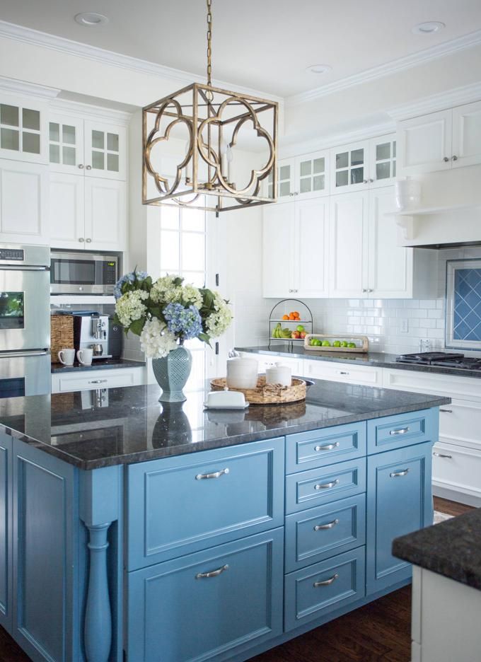 a kitchen with blue cabinets and an island