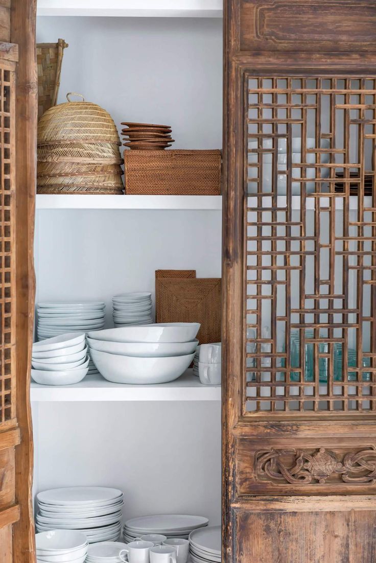 the shelves are filled with plates and bowls