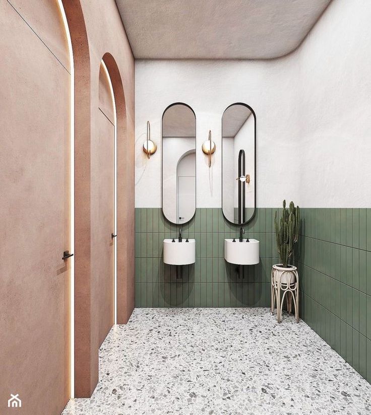 a bathroom with two sinks and three mirrors on the wall, along with a potted plant