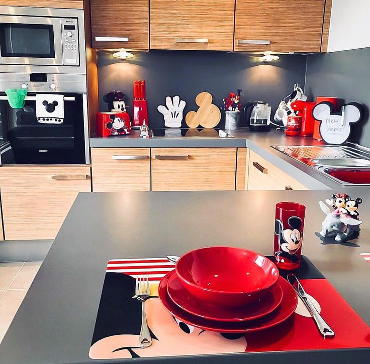 a kitchen with mickey mouse plates and utensils