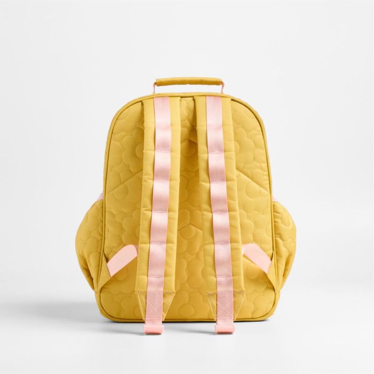 A backpack that's extra comfy and ready to handle all the adventures of the day. A pattern of quilted blooms add sunny vibes to the bag's yellow exterior, and contrasting pink trim gives it the perfect finish. Constructed of supremely durable polyester fabric that includes recycled plastic bottles, this medium knapsack's roomy interior holds everything your kid needs-books, school supplies, extra layers-and there's a padded pocket to keep their tablet protected. Outside pockets hold snacks, wate Cute Yellow Backpack For Students, Cute Yellow School Backpack, Cute Yellow Backpack For Back To School, Yellow Student Backpack For Back To School, Quilted Backpack For Back To School, Playful Yellow Bags For Back To School, Quilted Standard Backpack For Back To School, Playful Yellow Backpack For Back To School, Back To School Quilted Backpack