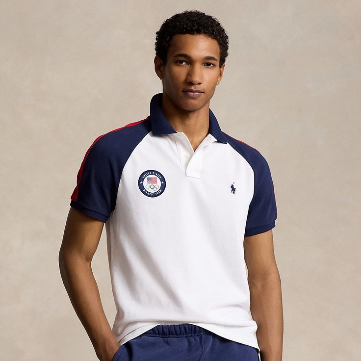 Part of the Polo Ralph Lauren Team USA Collection this Custom Slim Fit Polo shirt features an official logo patch of the U.S. Olympic Team and appliqués spelling out “USA.” Navy Top With Embroidered Logo For College, Team-colored Cotton Polo Shirt With Team Spirit Style, Team Spirit Cotton Polo Shirt In Team Colors, Sporty Logo Tops For College, White Sporty Polo Shirt For College, Sporty Cotton Polo Shirt For College, Casual Cotton Polo Shirt With Logo Patch, White Sporty Polo Shirt With Embroidered Logo, Casual Navy Polo Shirt With Embroidered Logo