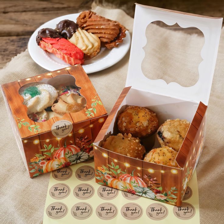 two boxes filled with pastries sitting on top of a table