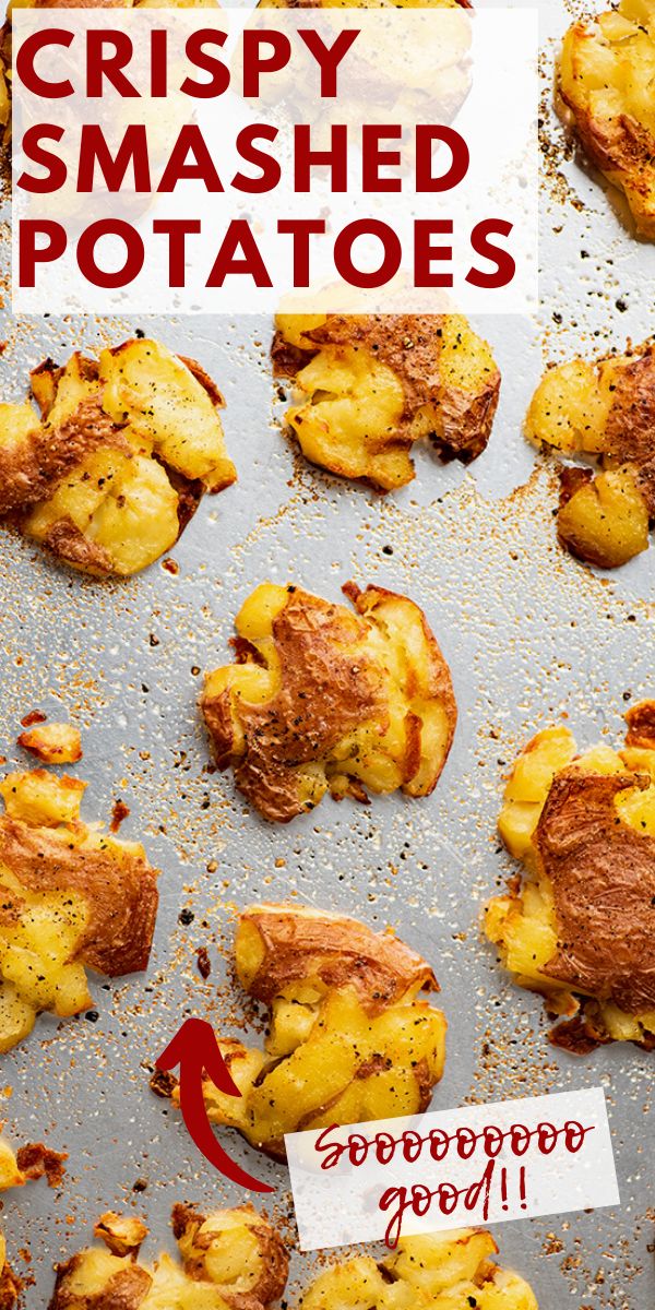 crispy smashed potatoes on a baking sheet with a red arrow pointing to the left