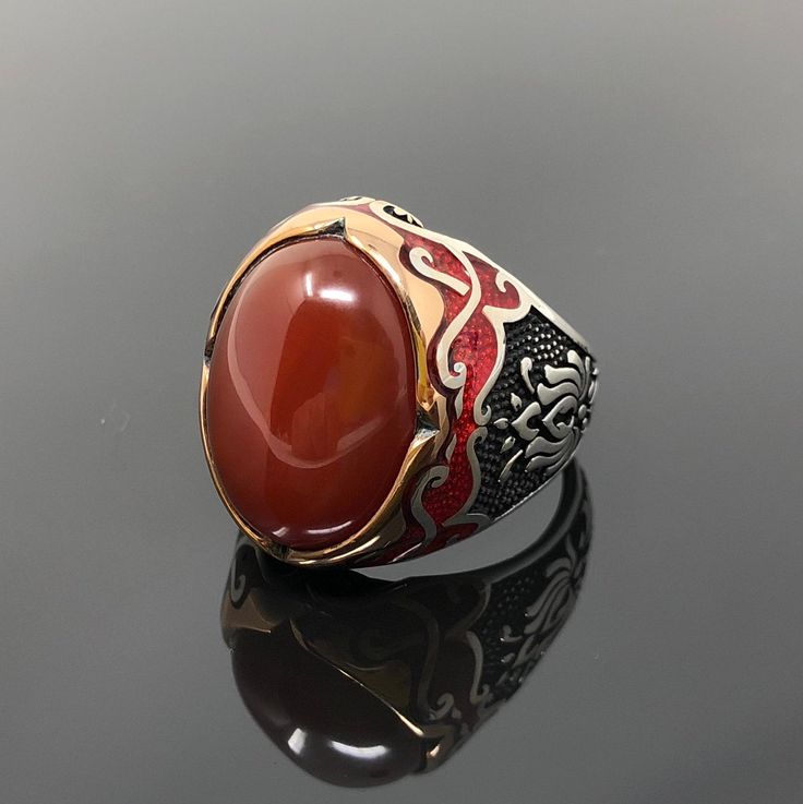 -Stone Type: Natural Red Agate (aka Aqeeq) -Stone Dimensions: 2.1 cm x 1.5 cm -Metal Type: Sterling Silver(925k) & Bronze Details (Yellow Part) -Weight of the Item: 17gr (Approx.) All items comes in a special gift box. If you don't see your size, please ask, we may produce your size. You are looking at the high quality handcrafted silver ring. All of our items have been designed and produced by ourselves ,so all our items comes with 1 year warranty as well. International shipping(customers f Red Inlay Ring Jewelry, Red Carnelian Signet Ring With Polished Finish, Red Ring With Inlay, Red Inlay Ring, Red Oval Enamel Ring For Gift, Oval Red Enamel Ring For Gift, Red Sterling Silver Ring With Inlay, Red Sterling Silver Rings With Inlay, Red Gemstone Enamel Ring Gift