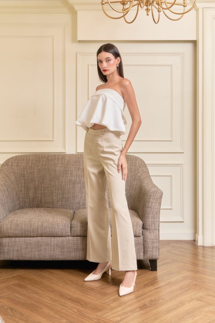 The Das Avaline Trousers are a perfect blend of sophistication and comfort, designed for the modern woman who values style and practicality. Made from high-quality, imported fabric, these trousers offer a luxurious feel and a flattering fit. The tailored design features a high waist and a sleek, straight-leg cut that elongates the legs, creating a streamlined silhouette. With their versatile and timeless appeal, the Das Avaline Trousers can easily transition from a professional office setting to an elegant evening out. Pair them with a chic blouse or the Das Lavinia Top for a look that exudes confidence and elegance. Chic Tailored Cotton Pants, Chic Fitted Wide Leg Pants For Summer, Elegant Cotton Wide Leg Pants, Elegant Stretch Beige Pants, Elegant Beige Stretch Pants, Chic Stretch Beige Dress Pants, Elegant Stretch Cotton Wide Leg Pants, Fitted High Waist Tops For Workwear, Elegant Non-stretch Cotton Pants