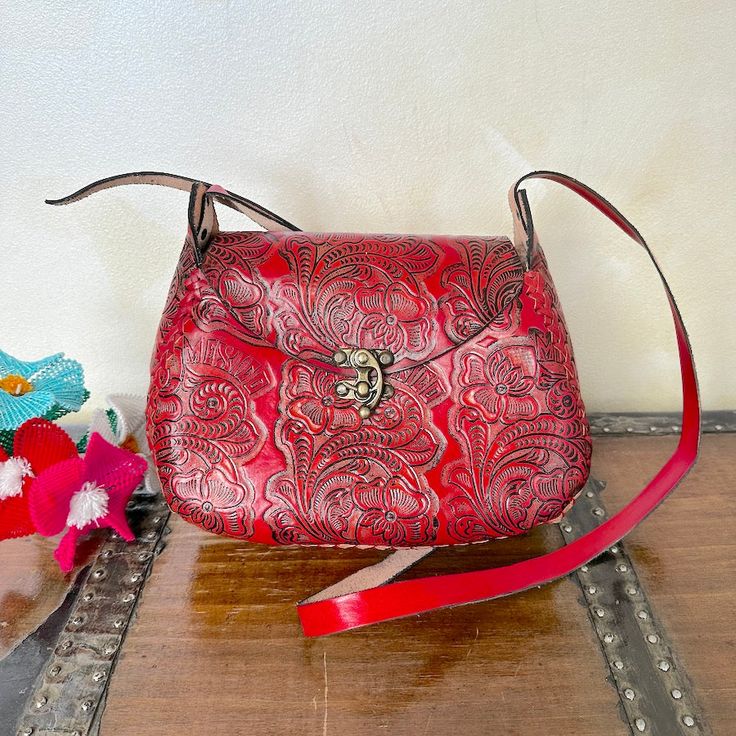 MADE IN MEXICO By: Mexican Artisans For: Women Color: red Dimensions: 9.5 x 8 x 2.5 Details: 100% Authentic Leather Style: Crossbody | Shoulder Bag Embossed Design Hook lock closure Adjustable & Non-Removable Strap: 22" Drop Contact us for more detailsPLEASE READ BEFORE PURCHASE: The picture is an ACCURATE REPRESENTATION.Colors in the pictures may vary a little by effects of light. Each product is handmade from Mexico causing differentiation and minor imperfections in each piece making them that Red Crossbody Satchel With Mobile Phone Bag, Red Everyday Mobile Phone Bag, Red Everyday Bag For Mobile Phone, Red Mobile Phone Bag For Everyday Use, Red Saddle Bag Satchel For Travel, Red Satchel Saddle Bag For Travel, Red Tote Flap Bag For Daily Use, Red Flap Bag With Detachable Strap For Everyday Use, Everyday Red Flap Bag