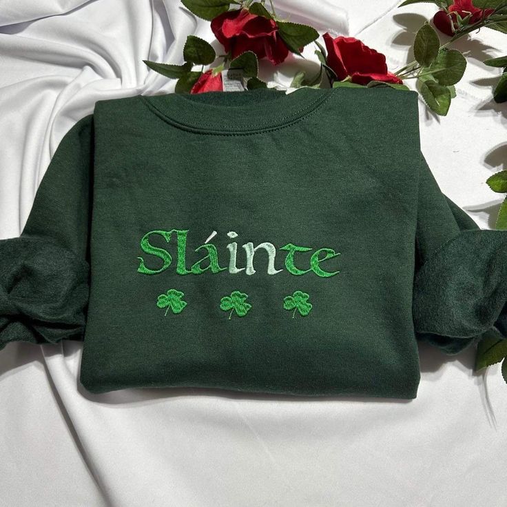 Stay warm and look stylish with this unique Slainte embroidered at the center of the chest This piece of clothing is perfect for any casual occasion. ST. Patrick's day funny shamrock embroidered crewneck . the high-quality fabric keeps you warm and comfortable, while the intricate embroidery brings a touch of elegance and charm to any ensemble. Whether you're out and about or just lounging at home, this sweatshirt is sure to make you stand out from the crowd. The sweatshirt also features a classic crew neckline and long sleeves for a timeless look. It's available in a range of sizes and colors, so you're sure to find the perfect one to suit your style. Plus, it's easy to care for, making it the perfect addition to your wardrobe. Product Benefits: * Stylish and fashionable  * Comfortable an Casual Sweatshirt With Embroidered Graphics As Gift, Green Embroidered Text Sweatshirt For Winter, Fall Sweatshirt With Embroidered Graphics For Gift, Fall Gift Sweatshirt With Embroidered Graphics, Casual Fleece Hoodie With Embroidered Text, Casual Sweatshirt With Letter Embroidery As Gift, Casual Embroidered Sweatshirt For Gift, Casual Embroidered Sweatshirt As Gift, Custom Embroidery Sweatshirt As Fall Gift