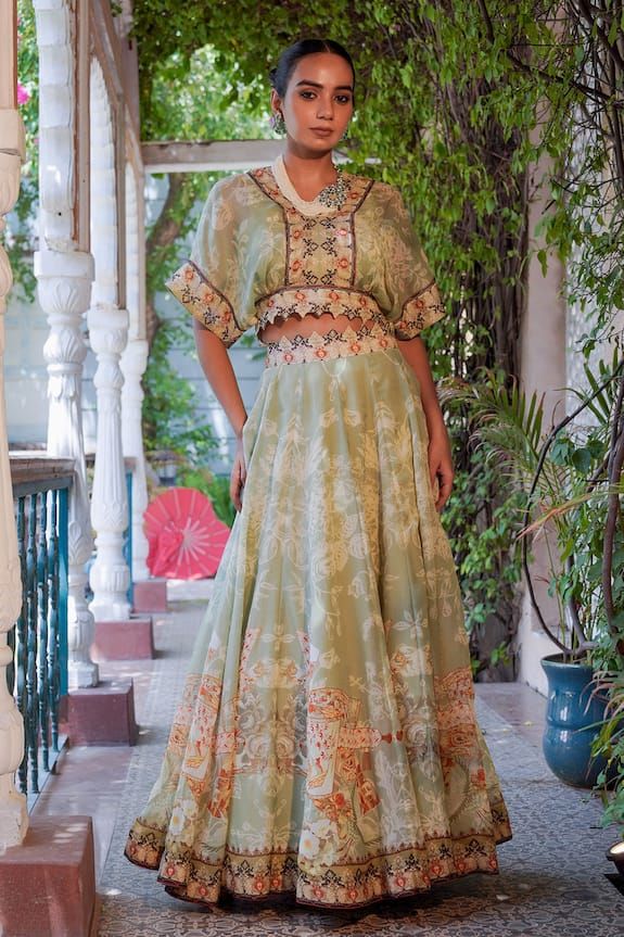 Green lehenga featuring floral, bird and geometric combination mix printed motifs and cut-out waistband. Comes matching printed cape. - Aza Fashions Bohemian Sets With Intricate Embroidery For Reception, Bohemian Green Lehenga With Floral Embroidery, Navratri Floor-length Sets With Printed Motifs, Bohemian Designer Lehenga With Printed Motifs, Green Floral Print Lehenga For Wedding, Bohemian Sets With Resham Embroidery Floor-length, Bohemian Floor-length Lehenga For Transitional Season, Green Floral Print Palazzo Set For Wedding, Festive Pista Green Dress With Printed Motifs