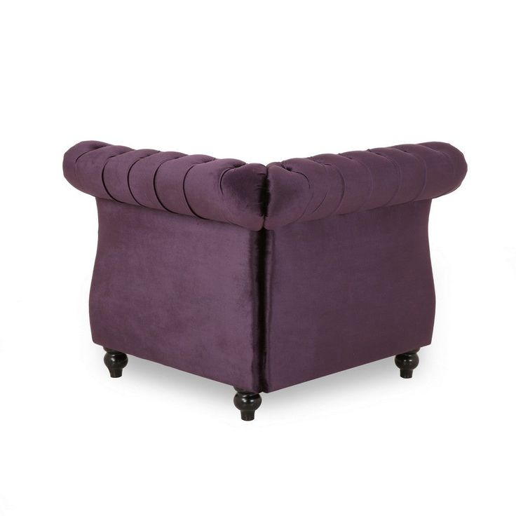 an upholstered purple velvet chair with black legs and buttons on the armrests