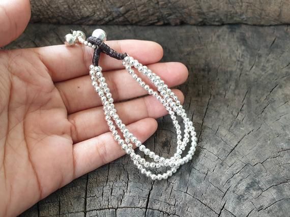 This bracelet made with 3 mm silver bead weaved together with dark brown wax cord and bell for closure with dangle. Length is approx. 7.5'' (B012) ♥..o00OoO,..Shipping..The item shipped by registered airmail within 3-5 working days after payment received. Usually takes 10-24 business days to reach destination.Feel free to contact me with any questions or requests.♥Thank you :)*~*~*~*~*~*~*~*~*~*~*~*~*~*~*~*~*~*~*~*~*~*~*~*~*~*~*~*~*~*~*~*~*~*~ Silver Braided Bracelet With Sliding Knot And Round Beads, Adjustable Silver Beaded Bracelet With Dangling Beads, Adjustable Silver Bracelets With Dangling Beads, Adjustable Silver Bracelet With Dangling Beads, Silver Adjustable Bracelet With Dangling Beads, Bracelet Simple, Silver Chains, Women Bracelet, Simple Bracelets