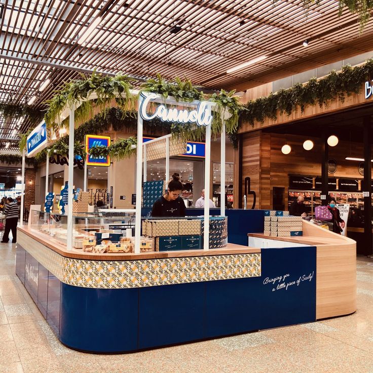 the inside of a food court with people walking around