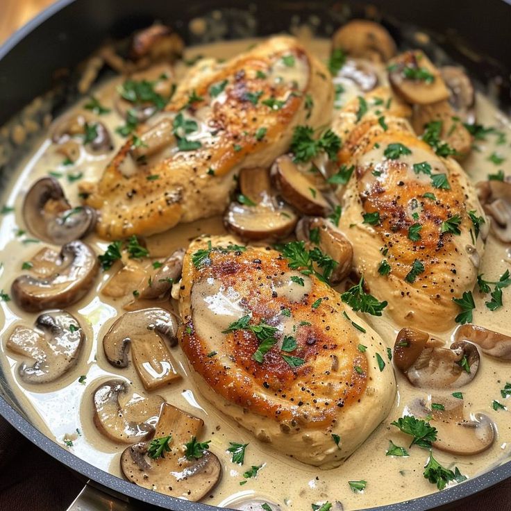 chicken with mushrooms and parsley in a skillet