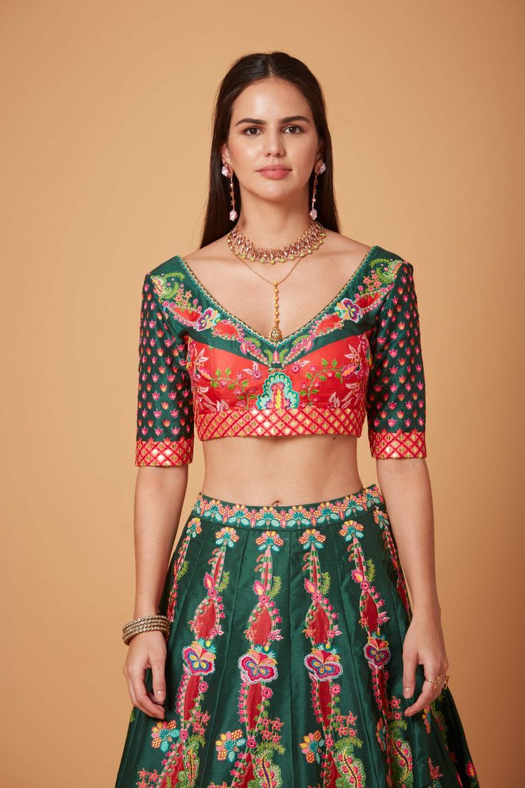 Editor's Note Green Red Embroidered Blouse and SB Signature Lehenga with Embroidered Maroon Net Scallop Dupatta. Fabric: Dupion, Net Color: Green, Red Care: Dry Clean Only Disclaimer: Product Color May Slightly Vary Due To Photographic Lighting Sources Or Your Monitor Setting. About the Designer Siddhartha Bansal, label epitomise its design philosophy touring around " Golden bird" nation to present day India, in the wanderlust for rich Craft and Culture presenting to the world . Vision is to giv V Flower, Blouse Yoke, Lehenga Pattern, Red Lehenga, Embroidered Lehenga, Lehenga Blouse, Trendy Blouses, Flower Motif, Green Blouse